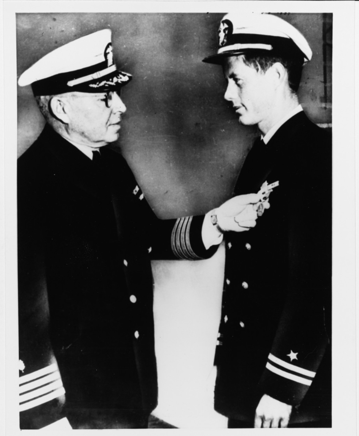 Kennedy receiving the Navy and Marine Corps Medal.